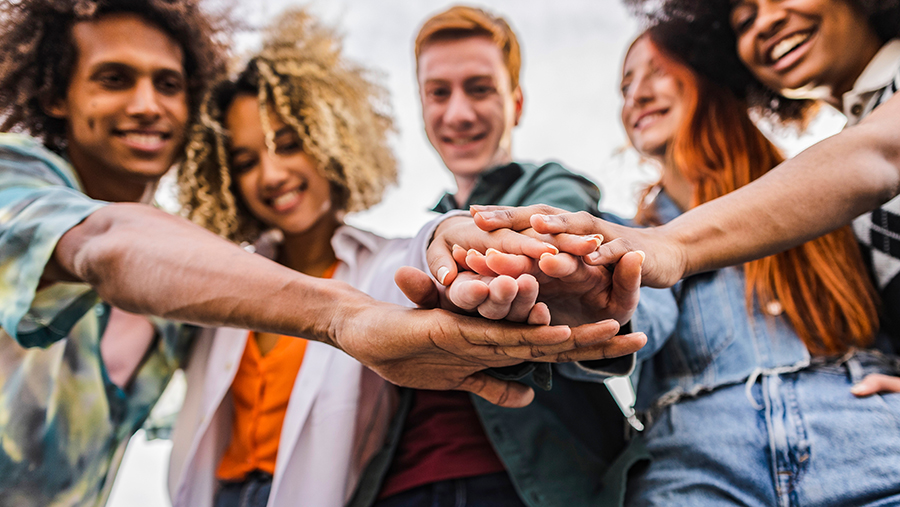 Group of students holding hands together